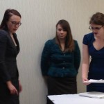 Seniors Myra Milam and Kristen Wright help Senior Maddie Ebert prepare for Finals in Lincoln-Douglas Debate.